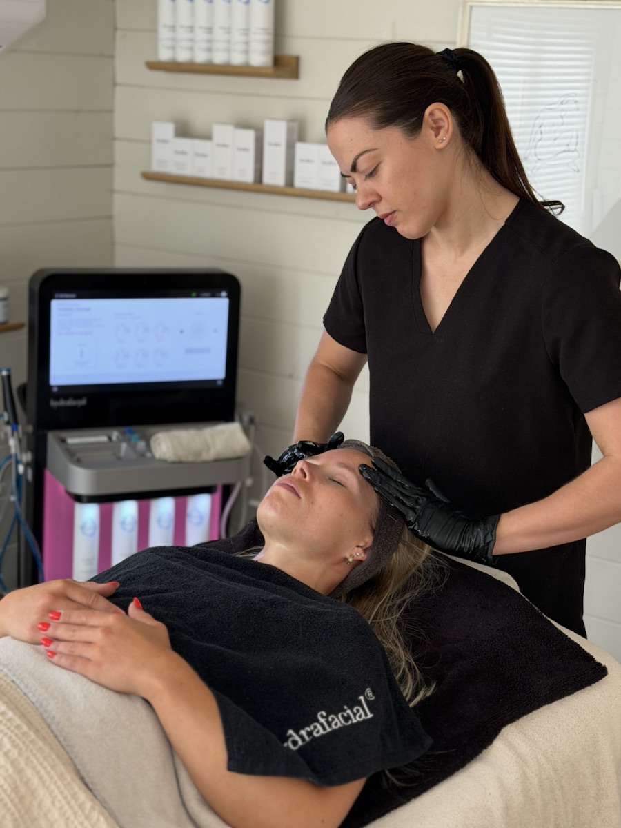 Adorabella practitioner providing a considered facial treatment